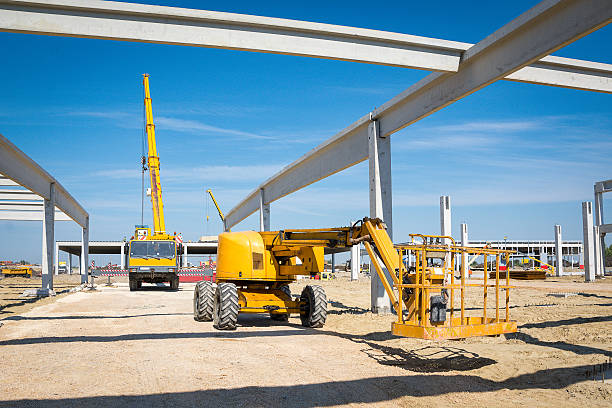 Construction lift platform with cage for worker safety standing high in the air